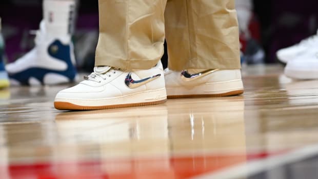 View of white and metallic Nike shoes.